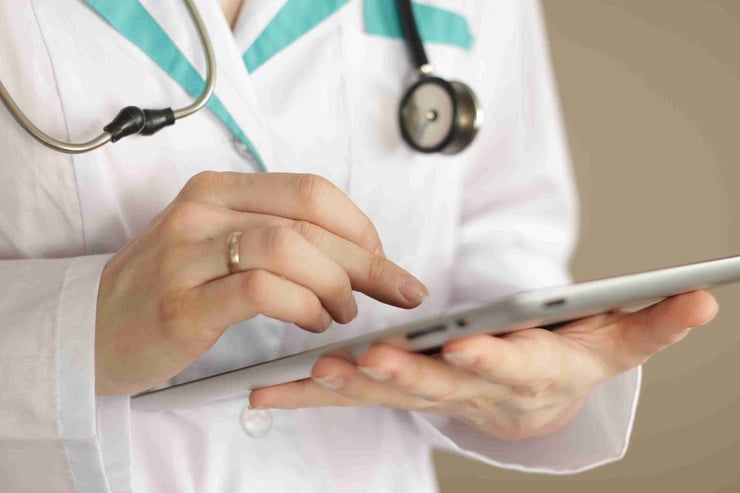 physician holding tablet
